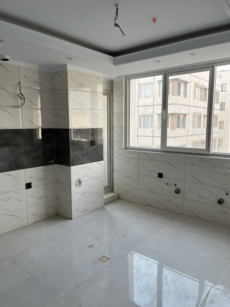 Kitchen before installation — window and services wall
