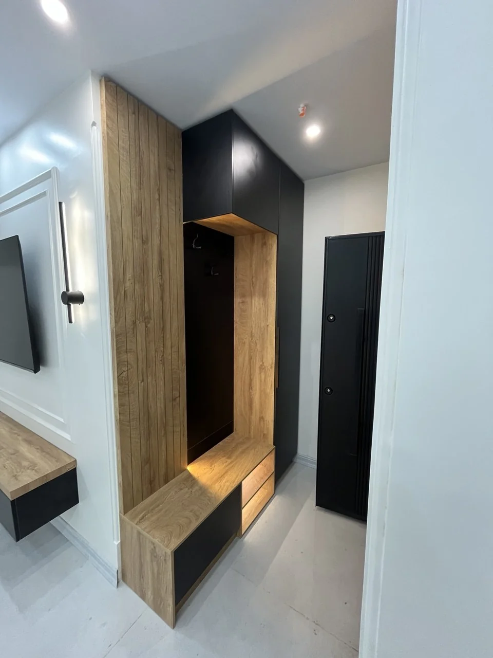 Actual installed entryway cabinet, seat, and hanging niche