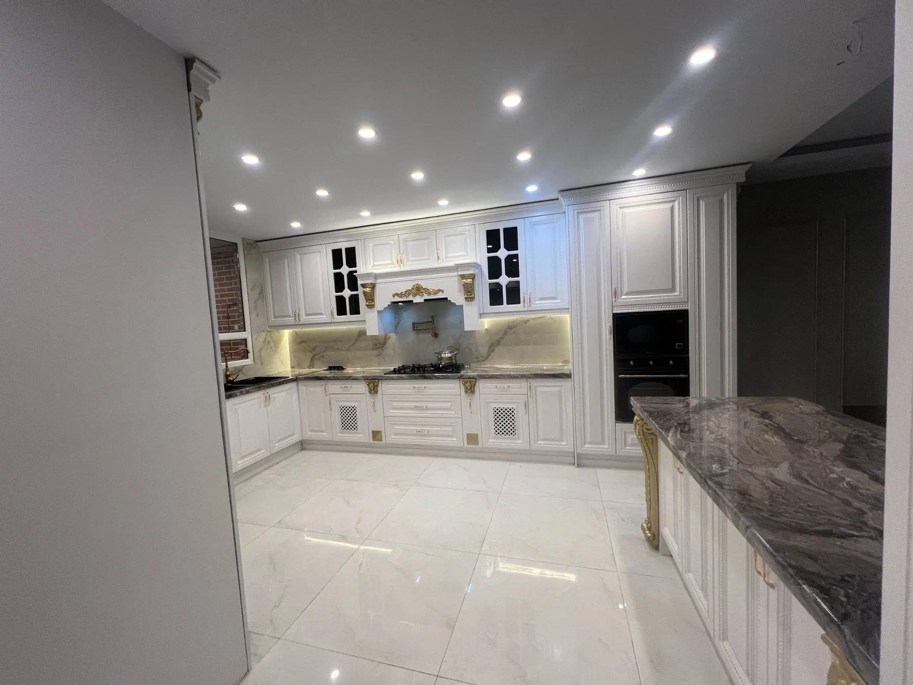 Completed membrane cabinetry project in Saadat Abad, Tehran; white decorative cabinets and dark stone-look counter