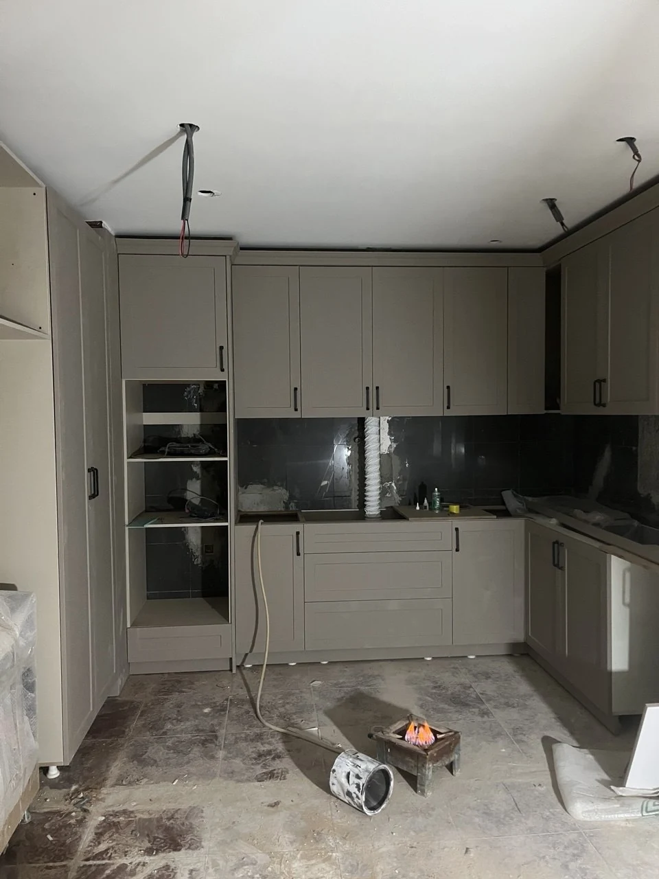 Cabinet doors and fronts in place before completion of kitchen installation