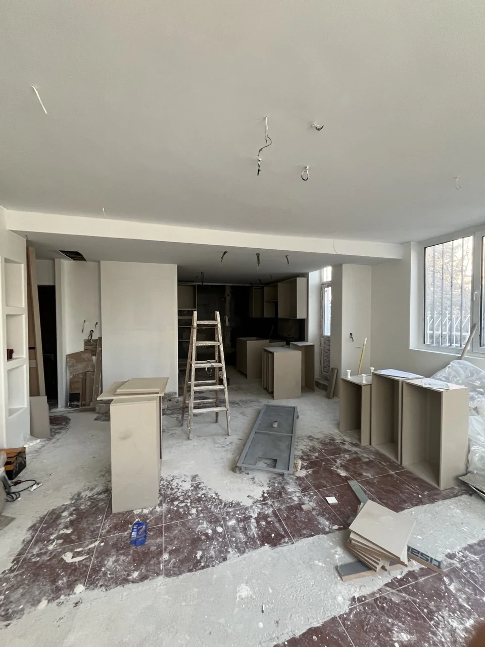 In-progress installation with cabinetry components in the renovation space